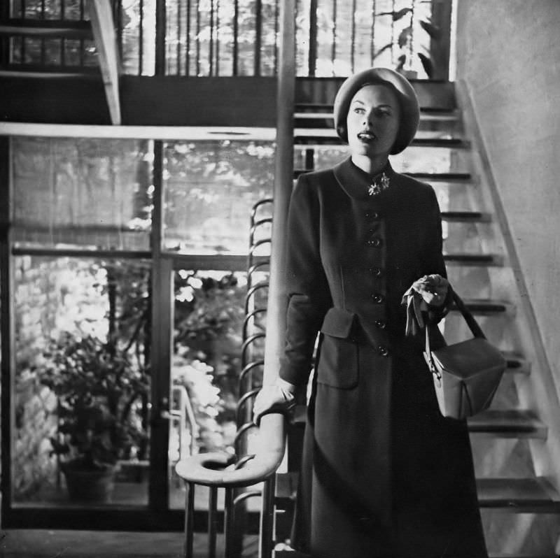 Meg Mundy in beautifully proportioned princess coat with turn-back cuffs and flat pockets in cocoa brown Melton wool from Simplicity Pattern 2136, hat by Lilly Daché, Harper's Bazaar, September 1947