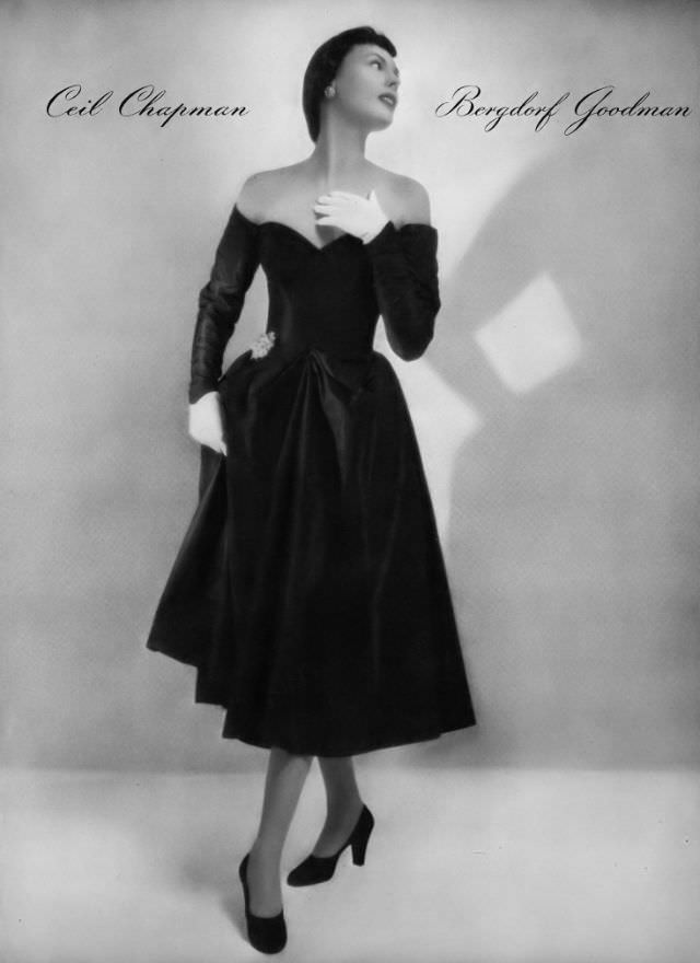 Meg Mundy in off-shoulder black taffeta cocktail dress by Ceil Chapman at Bergdorf Goodman, Vogue, January 1, 1947
