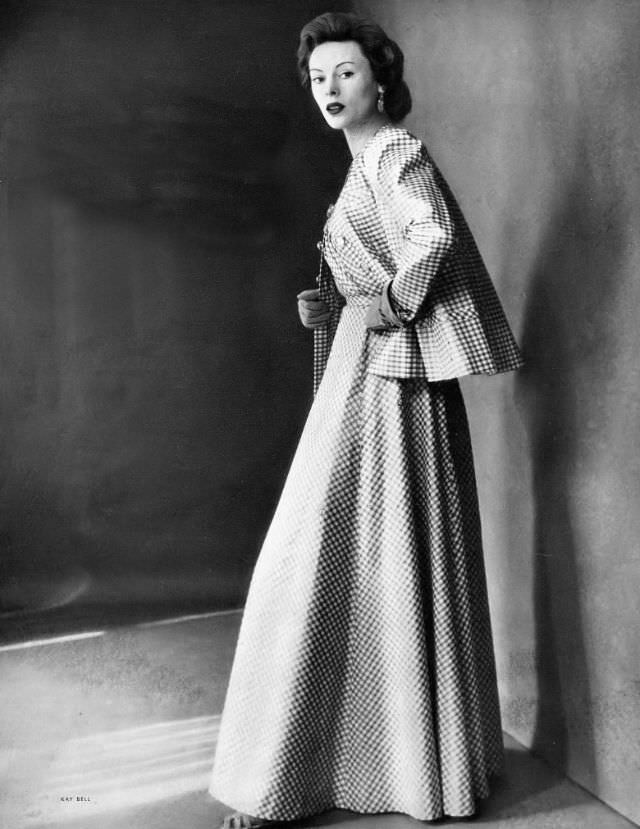 Meg Mundy in long evening dress and jacket of off-white cotton checked in gold Lurex by Mainbocher, Harper's Bazaar, May 1948