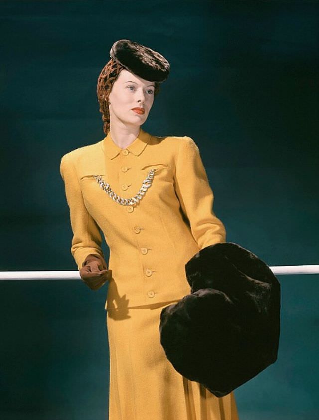 Meg Mundy in a yellow wool suit, accessorized with brown sealskin hat and muff, Vogue 1941