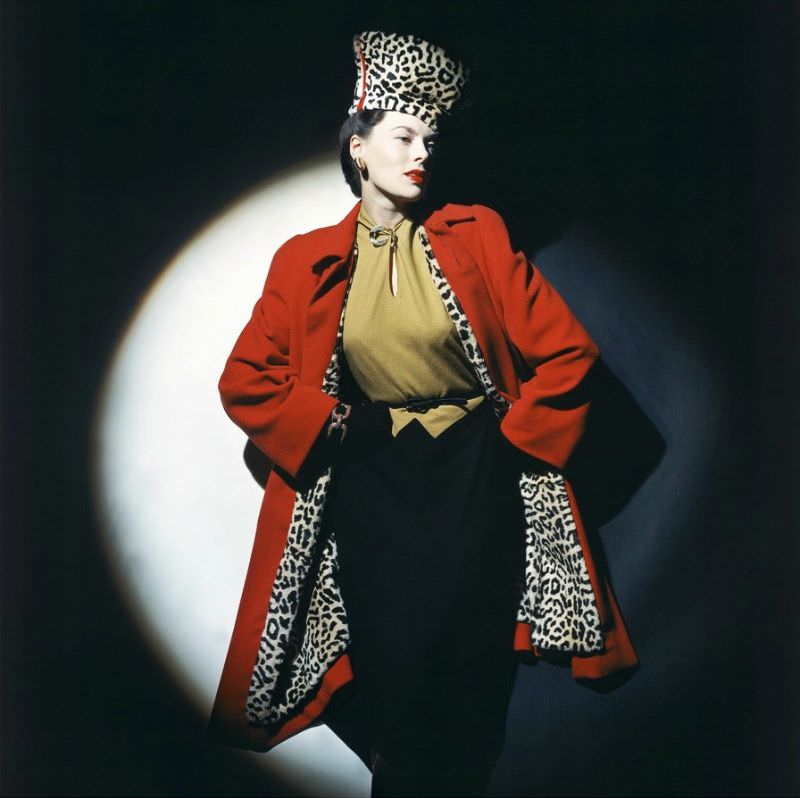 Meg Mundy in wool jersey two-toned dress from Young-Times worn under a red Forstmann wool coat lined in leopard-stenciled rabbit fur, 1942