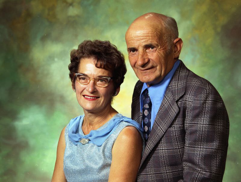 Mr and Mrs James Miller. Mrs Miller is wearing a light blue, sleeveless top. Mr Miller is wearing a light blue shirt with a tie and dark-colored plaid sports coat, September 15, 1973