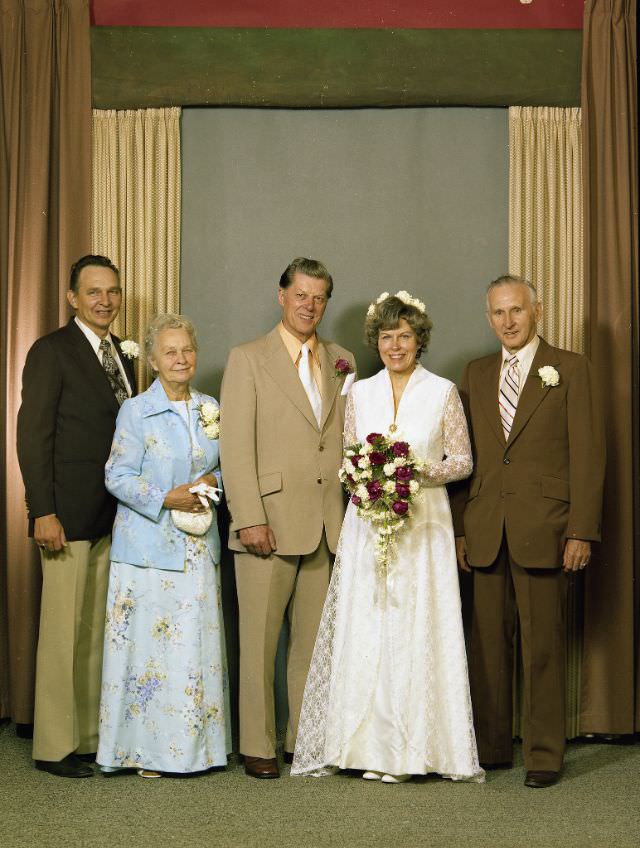 Married couple Gordon Webb and Anne Farrell. The bride is holding a bouquet of white and red flowers, June 24, 1977