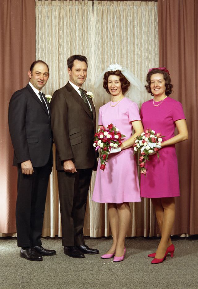 Wedding portrait of Mr. Couch and Mrs Raymond. The married couple are flanked by the best man (to the left) and the maid of honor (to the right), November 28, 1970