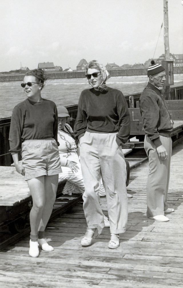 Two cheerful young ladies posing on a landing stage on a blustery summer's day. The photo was taken on the German North Sea island of Baltrum by a family from the city of Breslau, 1938