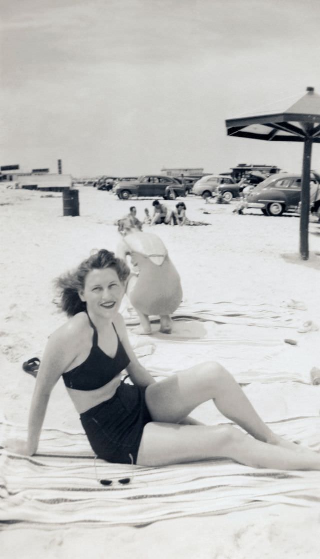 A young lady in two-piece swimsuit enjoying a day at the seaside.