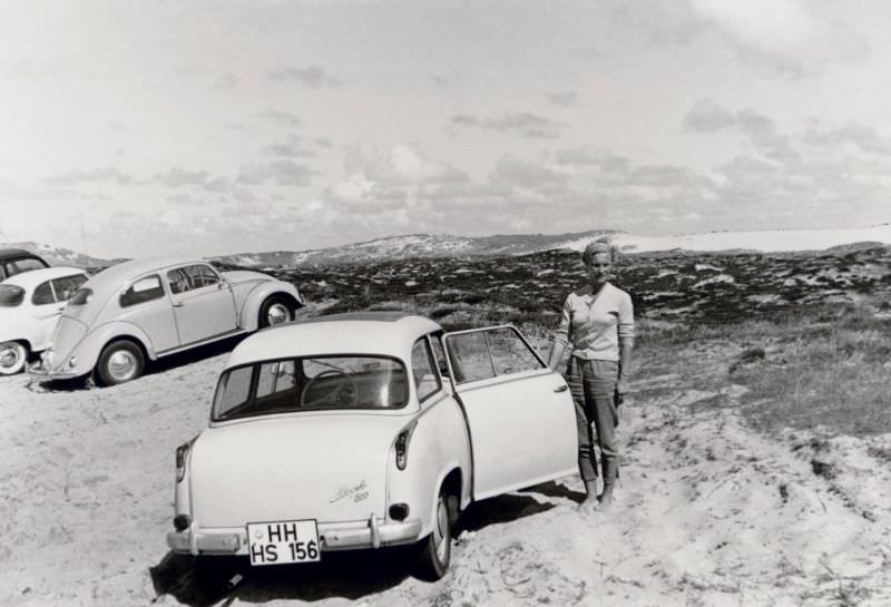 A young lady posing with a Lloyd LP 600 on a sandy beach in summertime, 1958