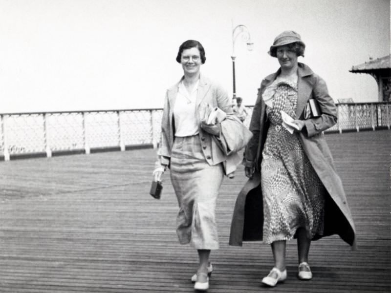 Two cheerful ladies strolling along the pier at Llandudno, Wales, circa 1930s