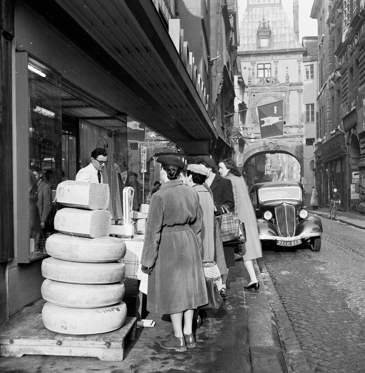 1950s: Female French Shoppers in Rouen Study Cheese Slices on Sale, France