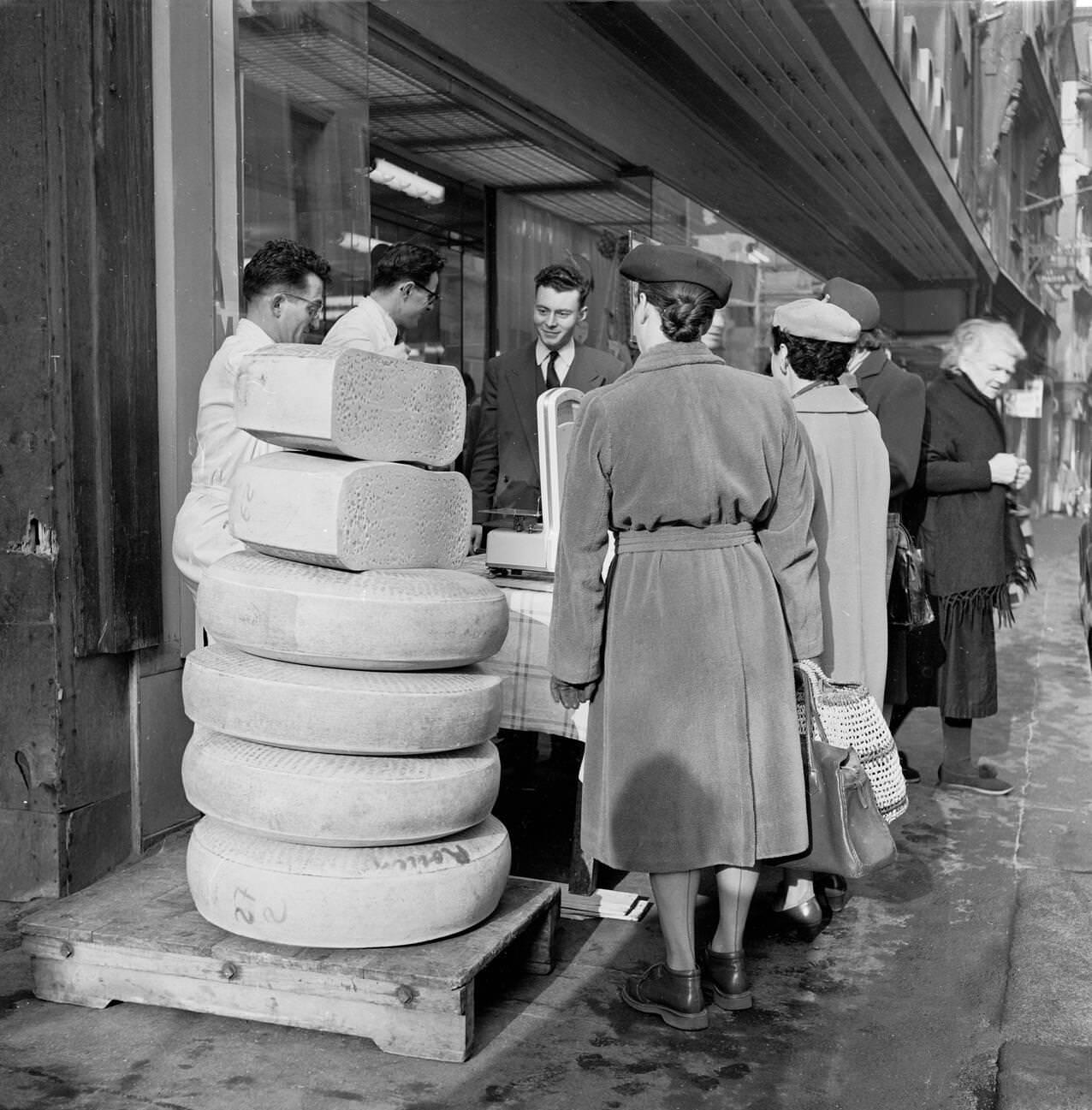 Female Shoppers in Rouen, Examining Cheese in the Street, France, 1950s