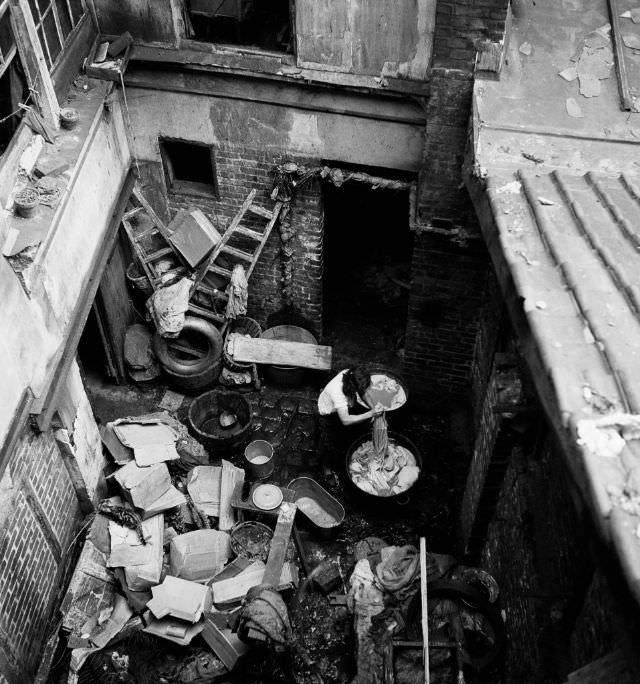 Woman doing laundry in the courtyard of 3, rue Marin-le-Pigny, Rouen, September 1951