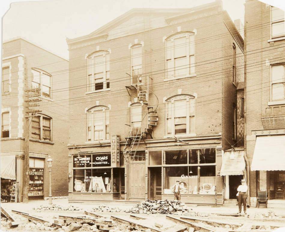 Street and sidewalk repair in front of a building on the 600 block of Vandeventer Avenue, north in 1920.