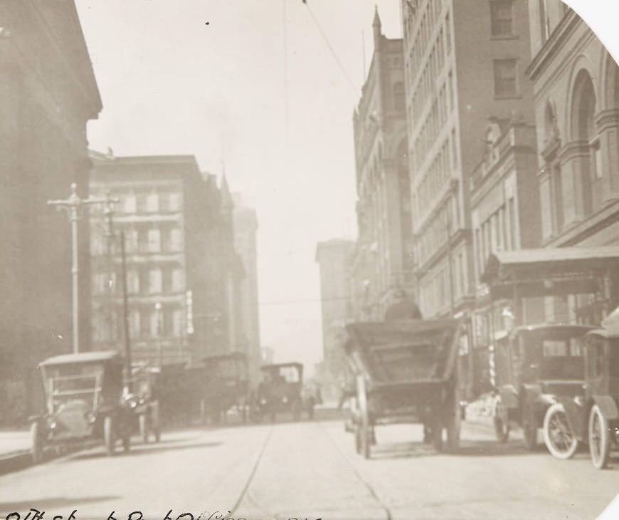 A view looking north on 8th Street near Olive in 1920, with a portion of the Old Post Office building visible on the west side of the street.