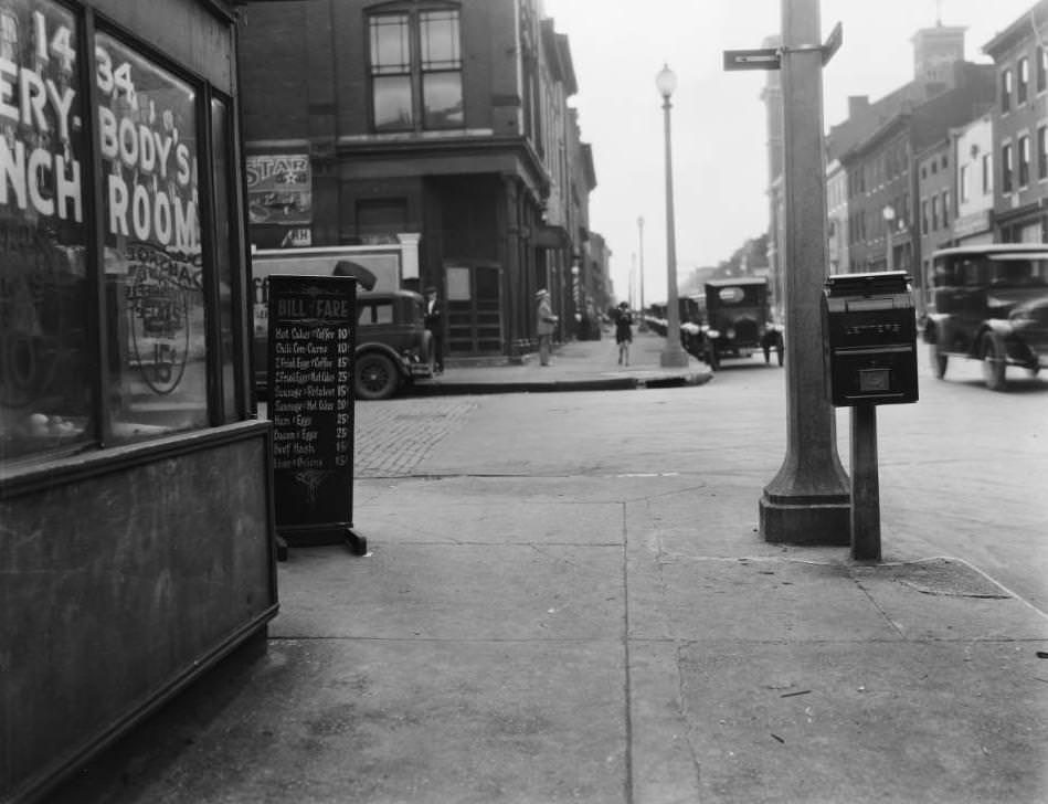 West view down Chestnut Street at the intersection with Fifteenth Street, with St. John the Evangelist and Apostle Catholic Church towers visible at far right, 1925