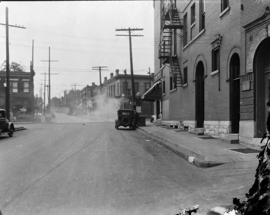 South view on Compton Ave. towards the intersection with Park Ave., with Kroger store on the left and Theodore Bros. Golden Bee Chocolate Co. on the right, 1925