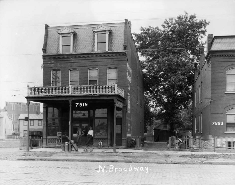 Street view of two buildings on North Broadway near Blase, with Fred G. Pohlman Auto Accessories and Hardware store visible, 1925