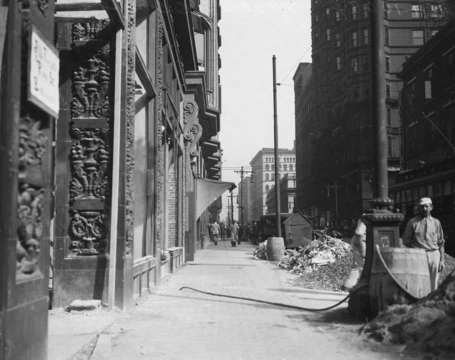 View from the west sidewalk on 8th St. looking north towards Pine St., with the Arcade building visible, 1925