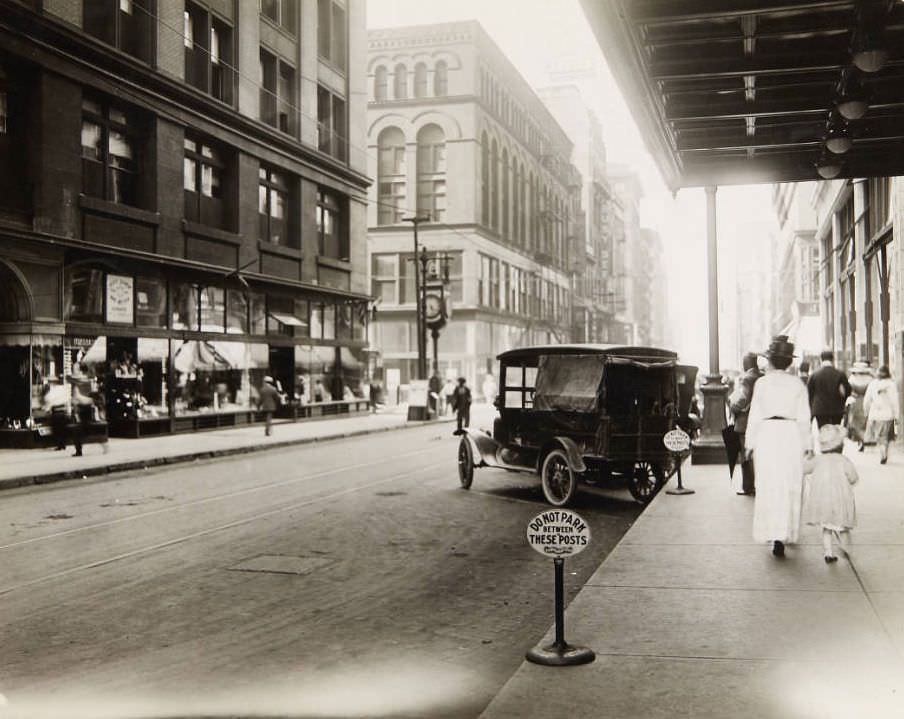 Cars parked along Seventh Street just north of Olive, with the Busy Bee Candy Co. visible in the distance, 1920