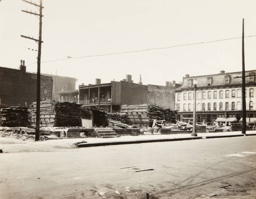 Stacks of lumber piled in a lot near the intersection of 23rd Street and Franklin Avenue, 1920