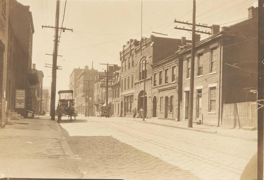 Horse-drawn wagon walking along the cobblestones of 11th Street near its intersection, 1920