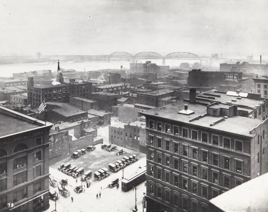 Building near the intersection of Fourth and Market streets, looking southeast with the spire of the Old Cathedral visible behind a building and the MacArthur Bridge, 1920