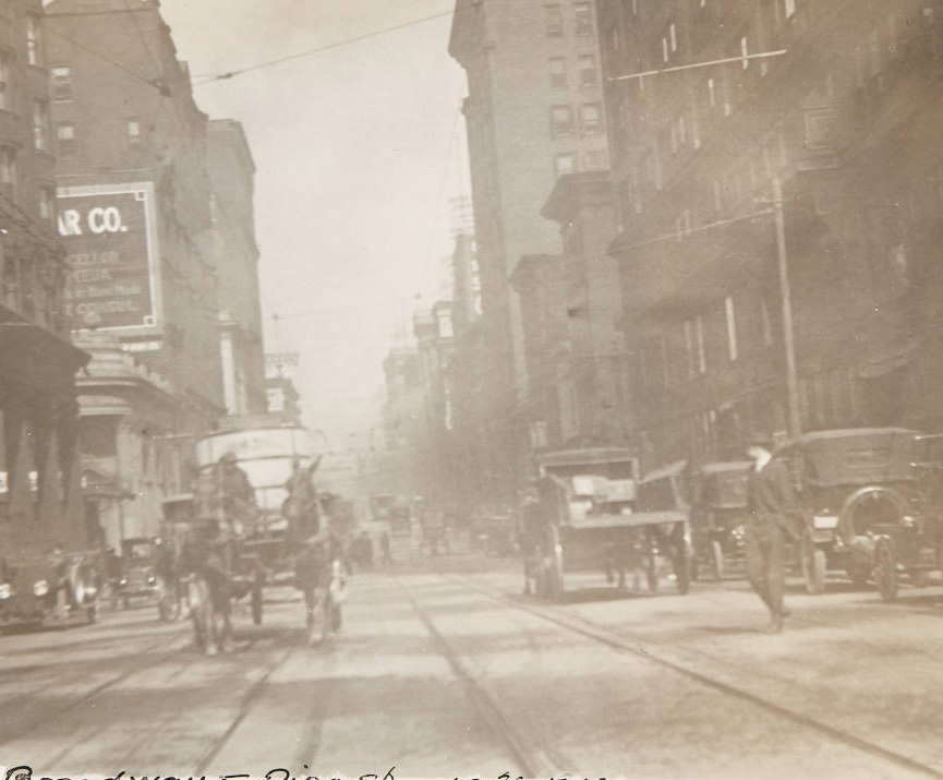 Automobiles and horse-drawn wagons in traffic on Broadway near its intersection with Pine Street, 1920