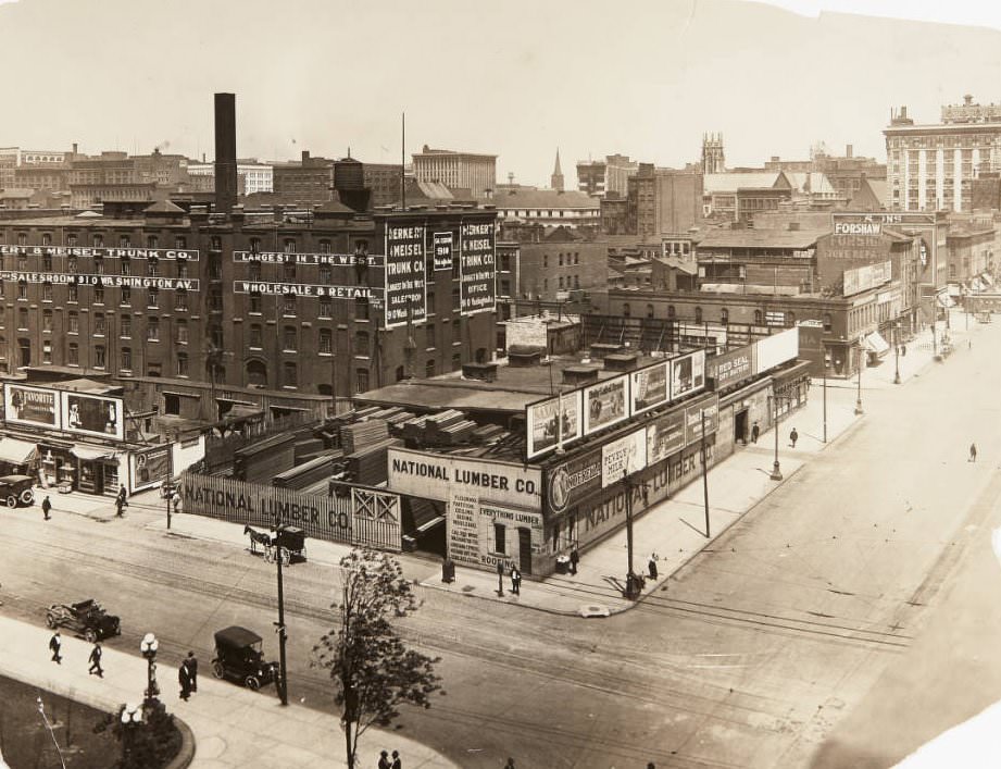 The northwest corner of 12th and Market Streets with National Lumber Co., Herkert & Meisel Trunk Co., and Forshaw Stove Repairs buildings, 1920