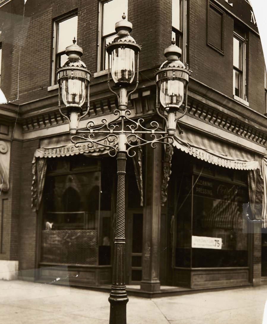 Streetlight at the corner of Grand and Lindell with Leonard Coiro's tailoring and clothes cleaning business located at 301 North Grand Ave, 1920