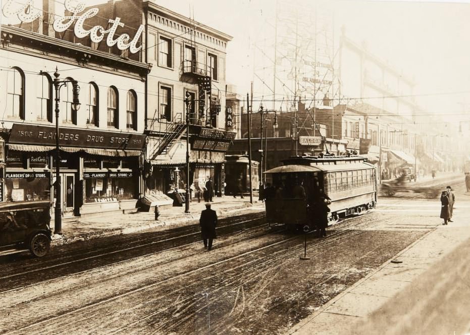 A streetcar rolling along Market Street near its intersection with 18th Street in 1920. Flanders Drug Store, Travelers Hotel, and United Cigar Stores Co. can be seen in the background.
