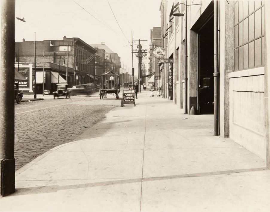Auto repair garage on Wash St in 1920. The sign in the middle of the image reads, "No Parking Between this Point. Wash St."