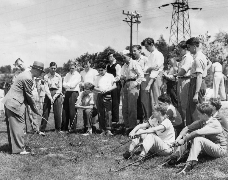 Alex Ayton, St. Louis Country Club professional, instructs a class of boy beginners in the fundamentals of the swing, 1940