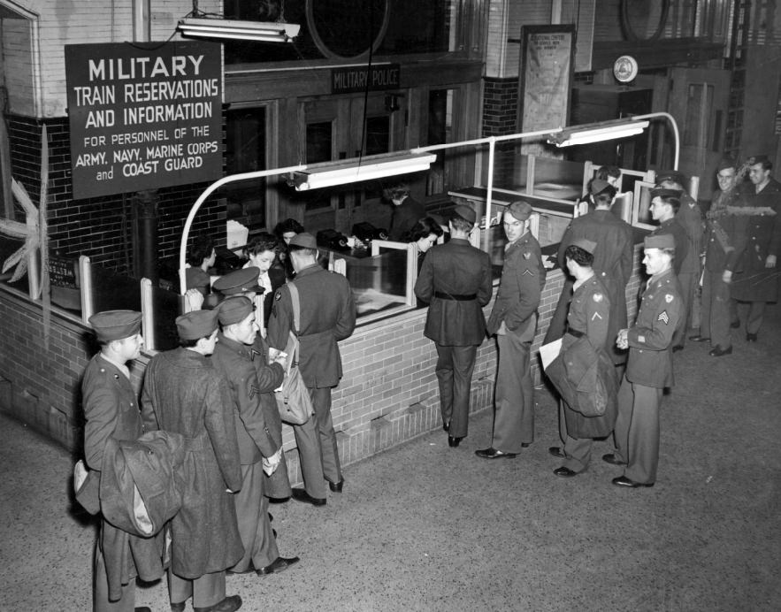 Soldiers gather at Union Station before the booth maintained by the Military Reservation Bureau to handle ticket matters for all servicemen on official business, 1944