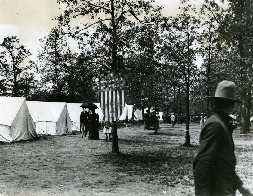 Light Battery A's camp ground with its banner hanging from a tree in Camp Stephens.