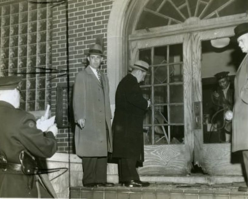 Police officers inspect scene of a bombing at the AFL bricklayers' union, 1953