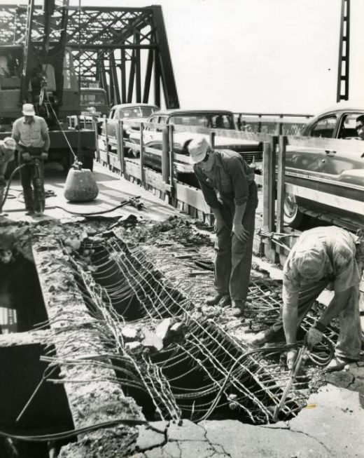MacArthur Bridge workmen break up old pavement in preparation for resurfacing the span, 1985