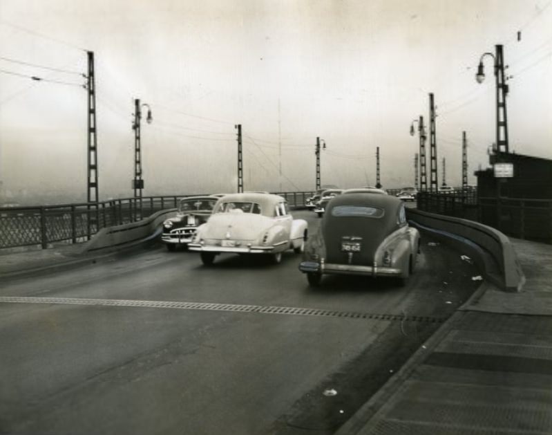 Heavy steel guard rails at the curb line protect curves on the east approach to MacArthur Bridge, where three persons have been killed in less than eight days, 1950