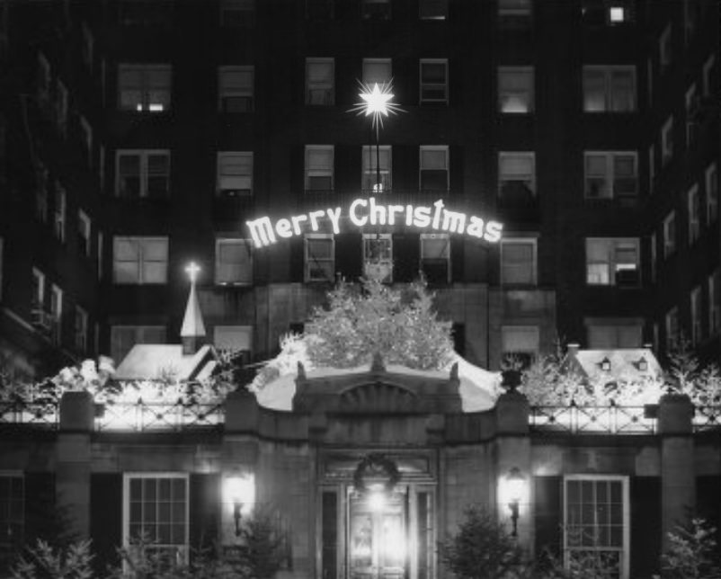 A winter scene with an animated Santa Claus and reindeer at the Winston Churchill Apartments, 1957