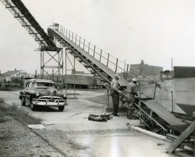 Workers at the Central Concrete Company plant at 2231 Papin St. began repairing the long conveyor belt which carries cement and gravel to the mixer, 1953