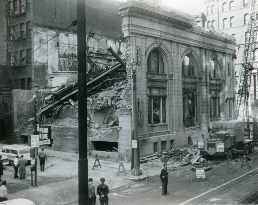 A wall of the old Telegraphers' National Bank Building forms a pile of debris after its sudden collapse during wrecking operations at the Broadway and Pine street site, 1958