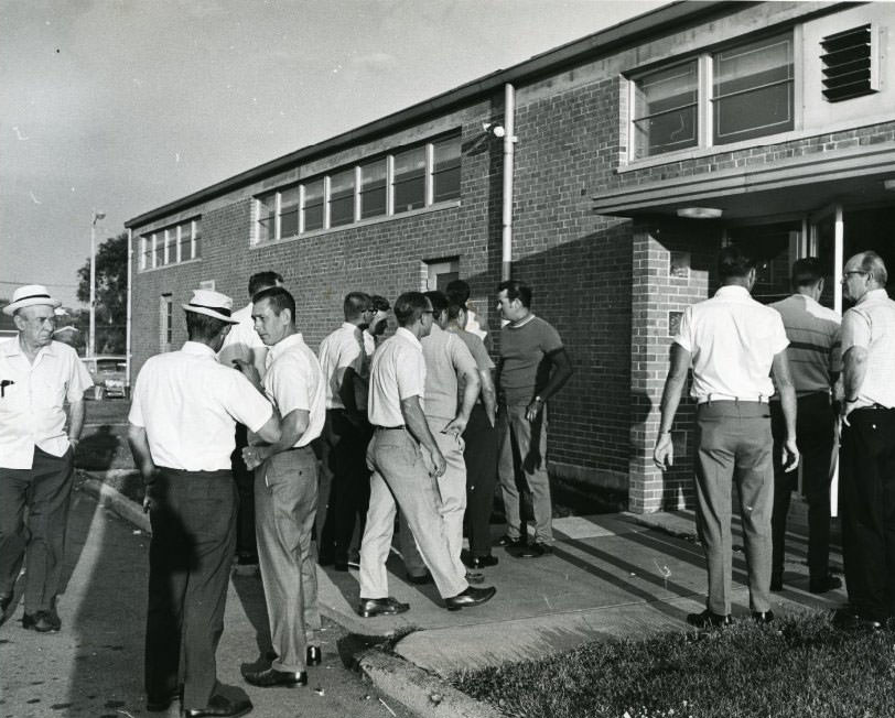 Iron workers going into the Iron Workers Union Hall for a meeting, 1960