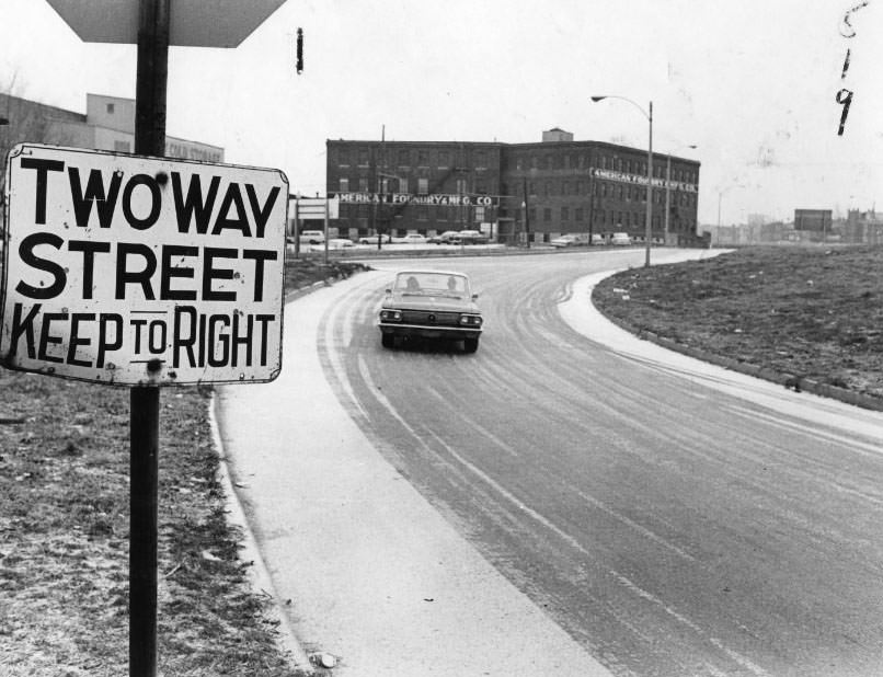 Arrows point to "Two Way Traffic-Keep Right" signs (enlargement below) on south curb at Branch street at west branch of Branch street exit from Interstate 70, 1960