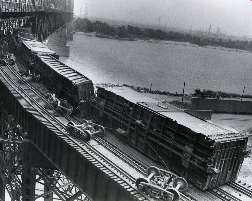 Cars lie without wheels after derailment on MacArthur Bridge, 1973