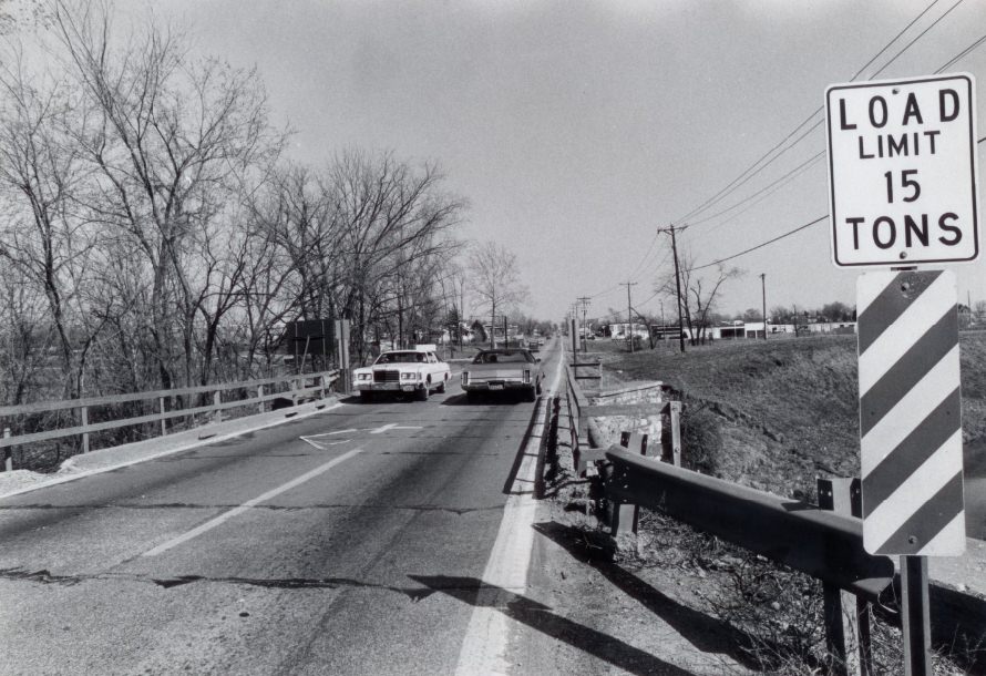 A two-lane bridge on Dorsett Road three-quarters of a mile east of Interstate 270 carries a 15 ton weight limit which is not always obeyed, 1977
