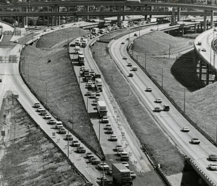 Traffic of the Poplar Street Bridge on the East Side is bottle necked by barricades, 1977