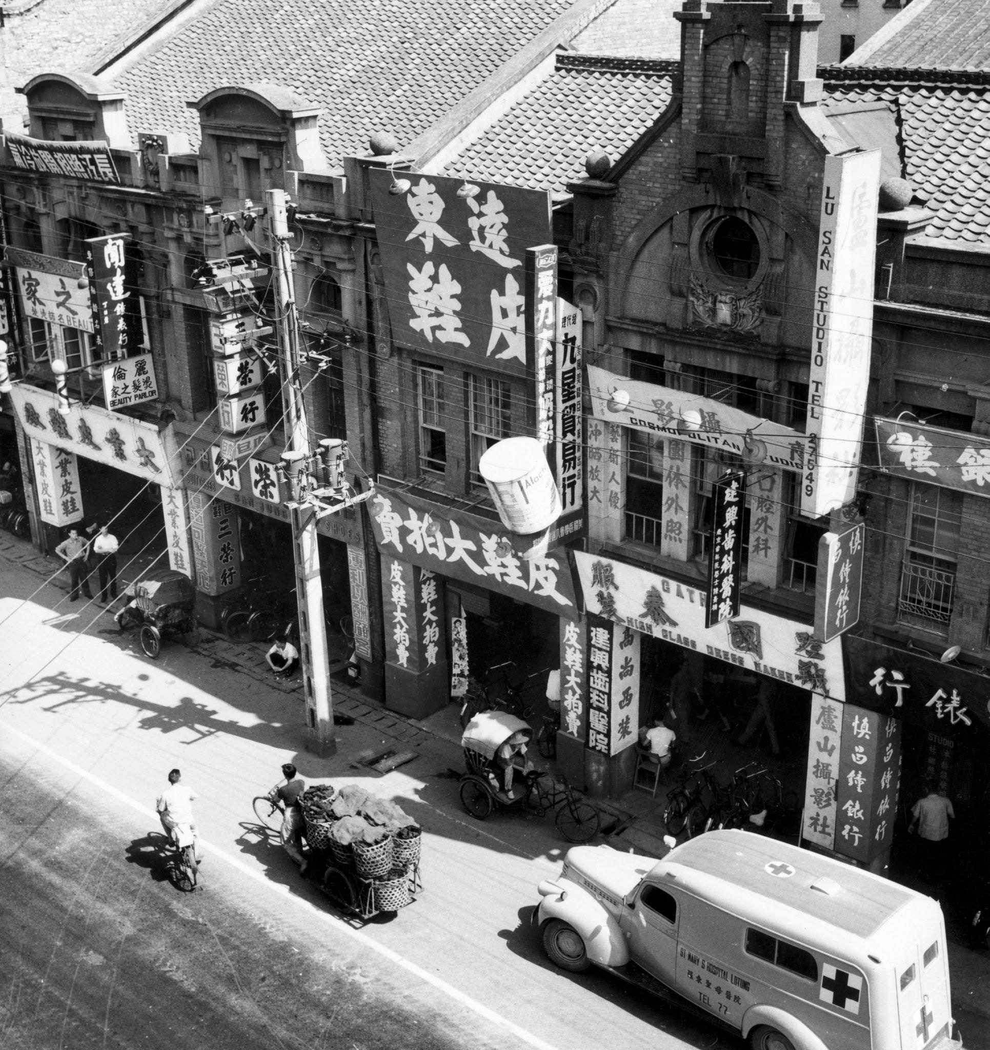 Buildings covered with banners written in Chinese characters at Chung Hwa Road, Taipei, Taiwan, 1955