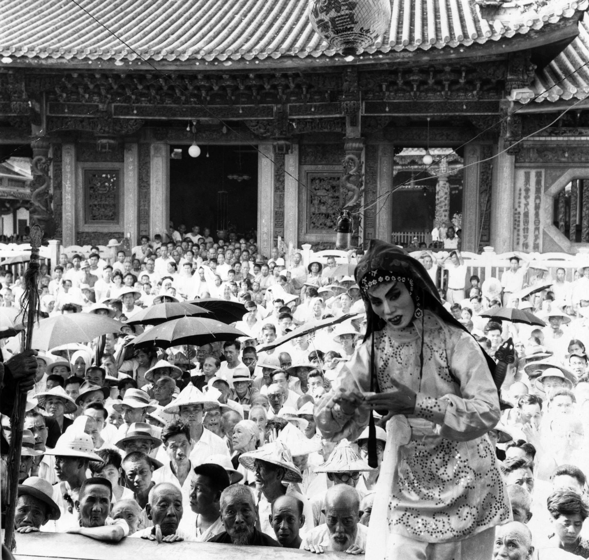 A Chinese classical actress during a performance outdoors at Taipei watched by a large audience, Taiwan, 1955