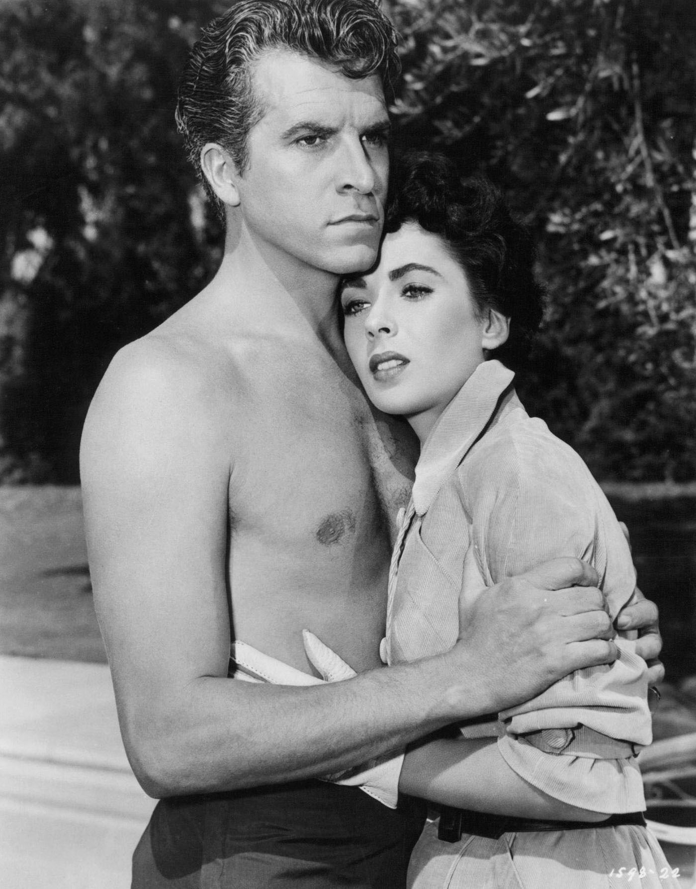Fernando Lamas embraces Elizabeth Taylor in a scene from 'Girl Who Had Everything' (1953).