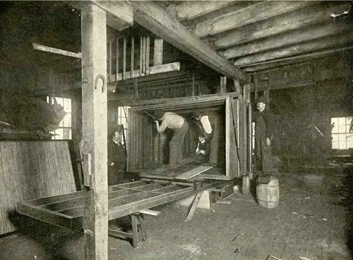 J. A. Anderson (left) overseeing mammoth camera construction.