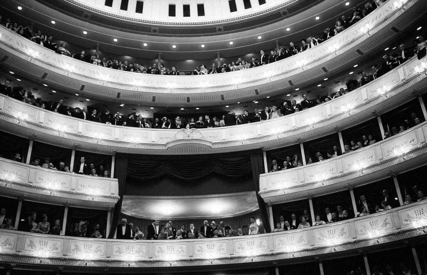 A crowd of elegant people attending the reopening of the Vienna State Opera from the gallery of the theatre in November 1955.