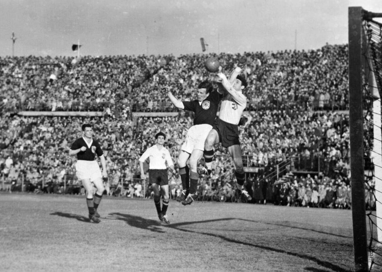 A tussle for the ball in front of the football match between Austria and Scotland at Vienna Stadium, May 1955.